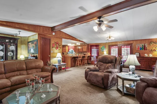 a living room with furniture and a gym