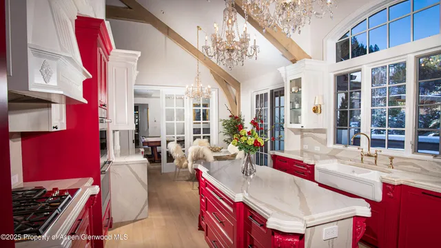 a living room with furniture and floor to ceiling windows