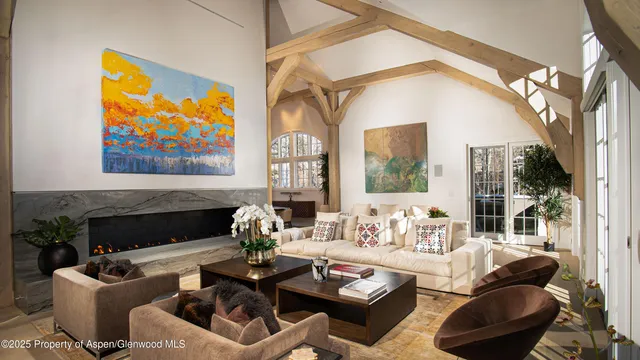 a living room with furniture fireplace and flat screen tv
