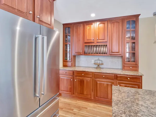 a kitchen with stainless steel appliances granite countertop a refrigerator and a sink