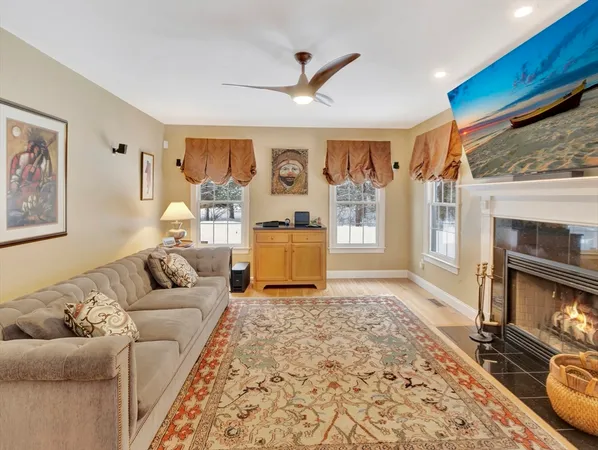 a living room with furniture and a fireplace