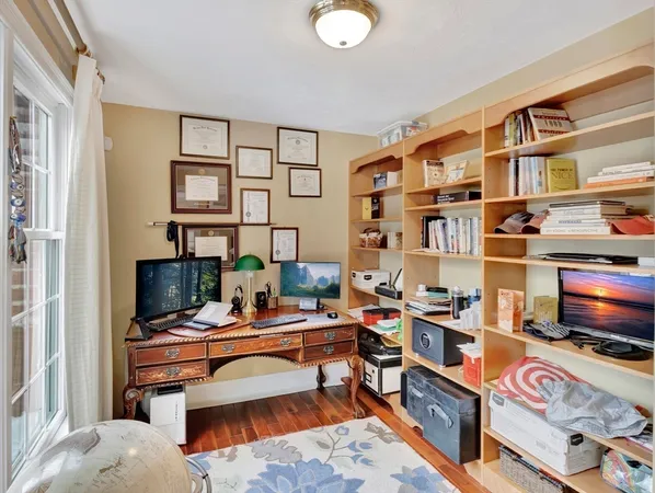 a bedroom with furniture and a flat screen tv