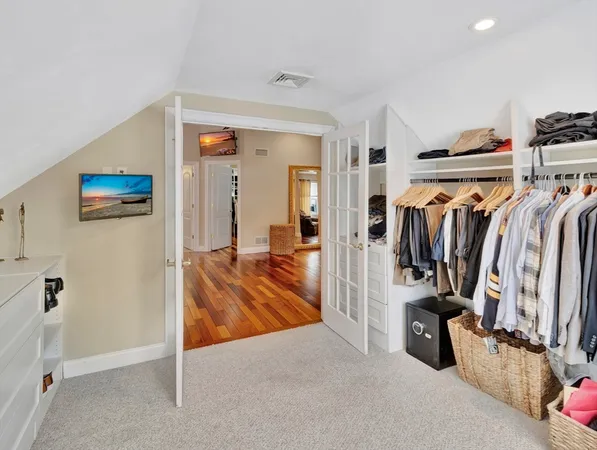 a view of walk in closet with clothes and shoes