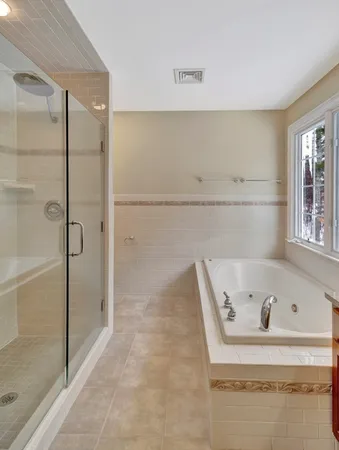 a bathroom with a bathtub and a shower