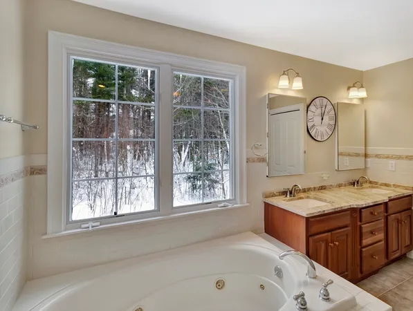 a bathroom with a tub sink and window