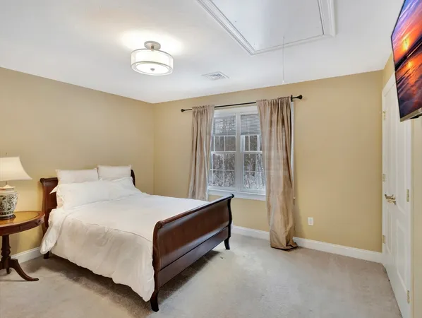 a bed sitting in a room next to a window