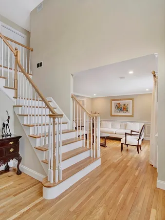 a view of entryway and hall with wooden floor