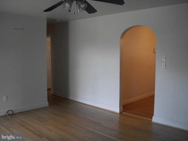an empty room with wooden floor and closet