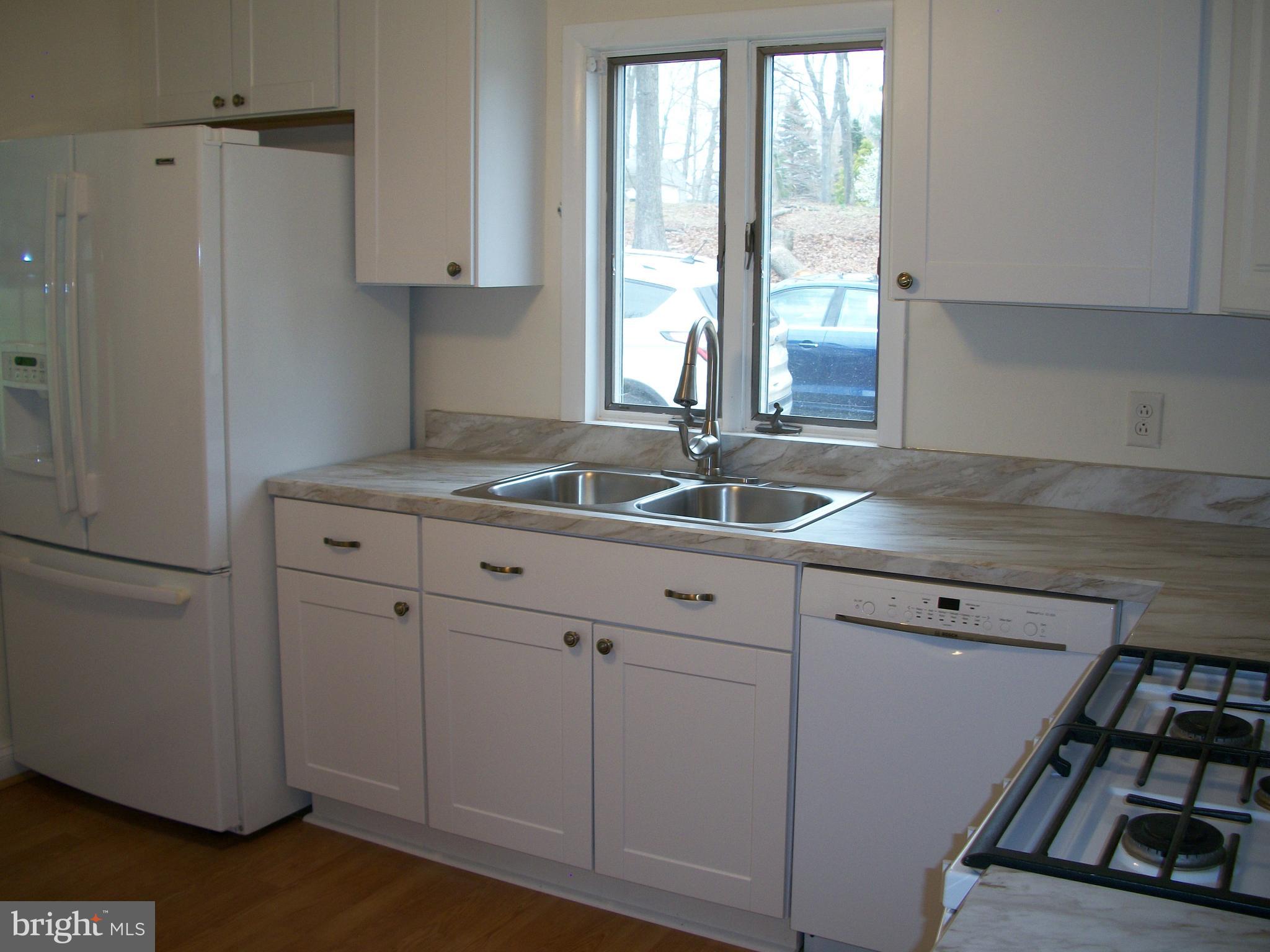 1102 Prospect Mill Road Bel Air, MD 21015 - Photo 9 of 18 a kitchen with cabinets appliances and a window