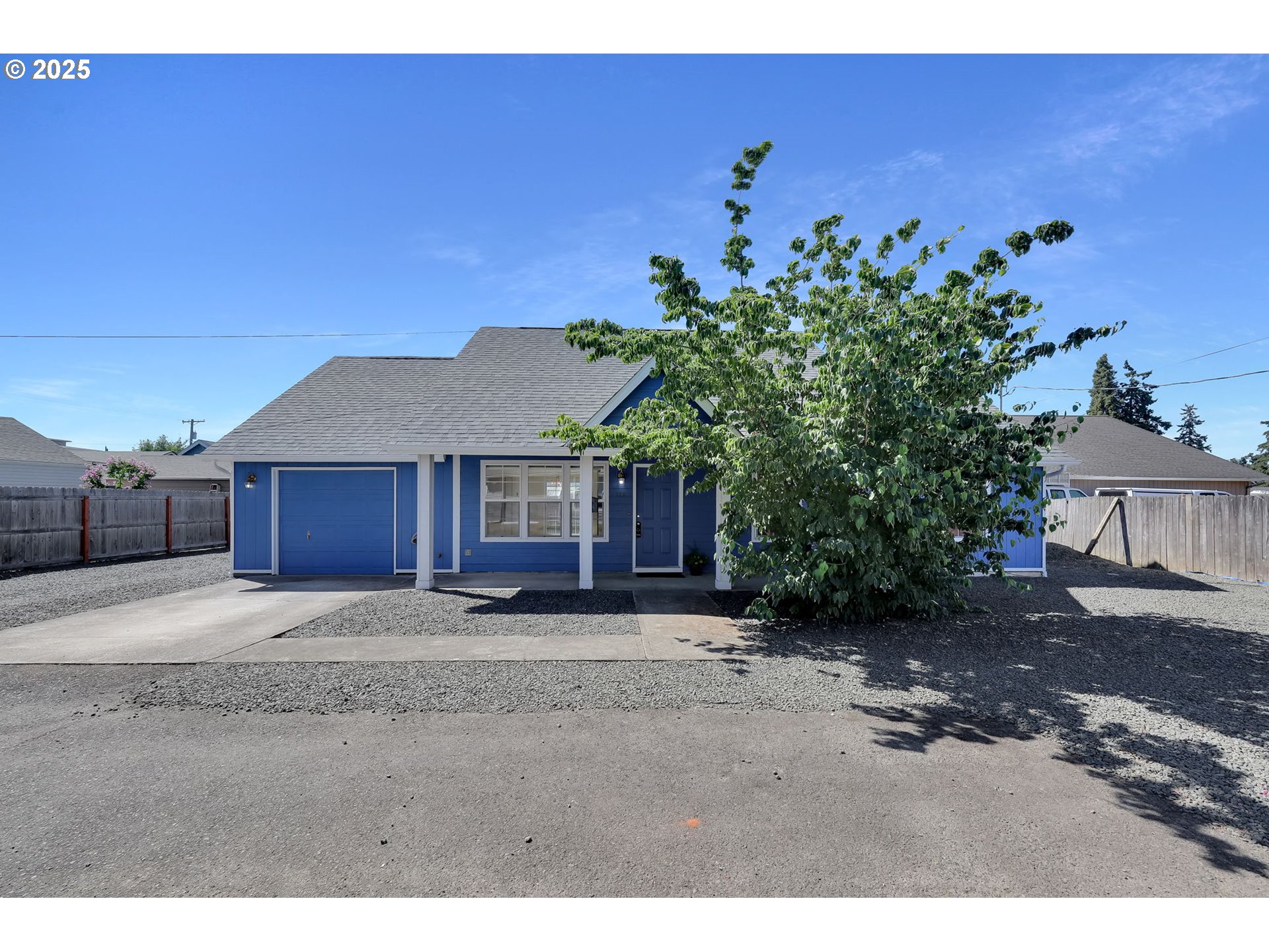 176 19th Street Springfield, OR 97477 - Photo 1 of 35 a view of a house with a tree in the background