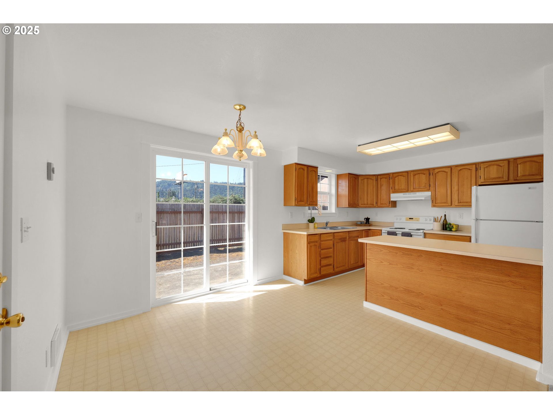 176 19th Street Springfield, OR 97477 - Photo 11 of 35 a open kitchen with granite countertop a sink cabinets and a large window