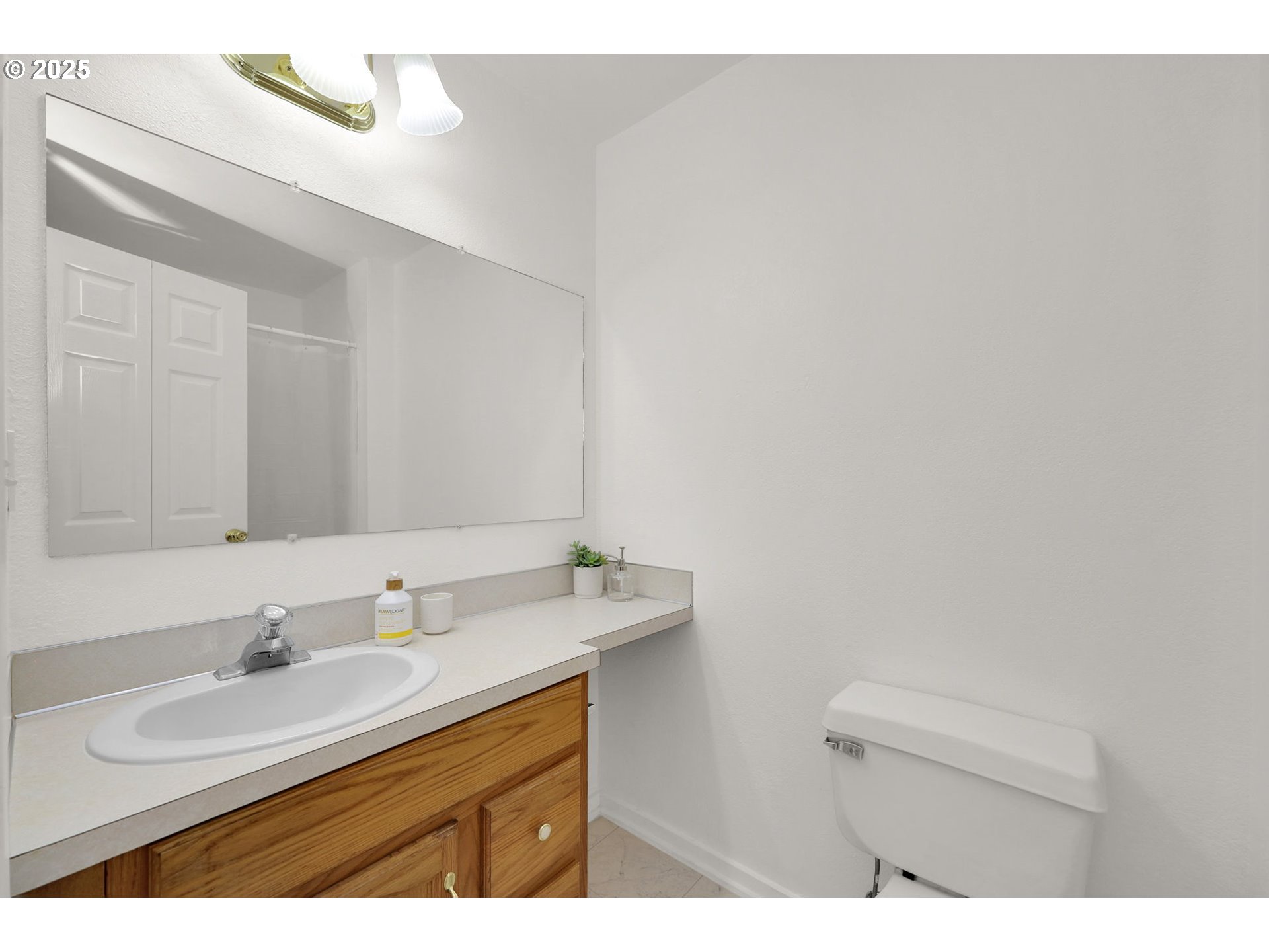 176 19th Street Springfield, OR 97477 - Photo 27 of 35 a bathroom with a sink a mirror and a toilet