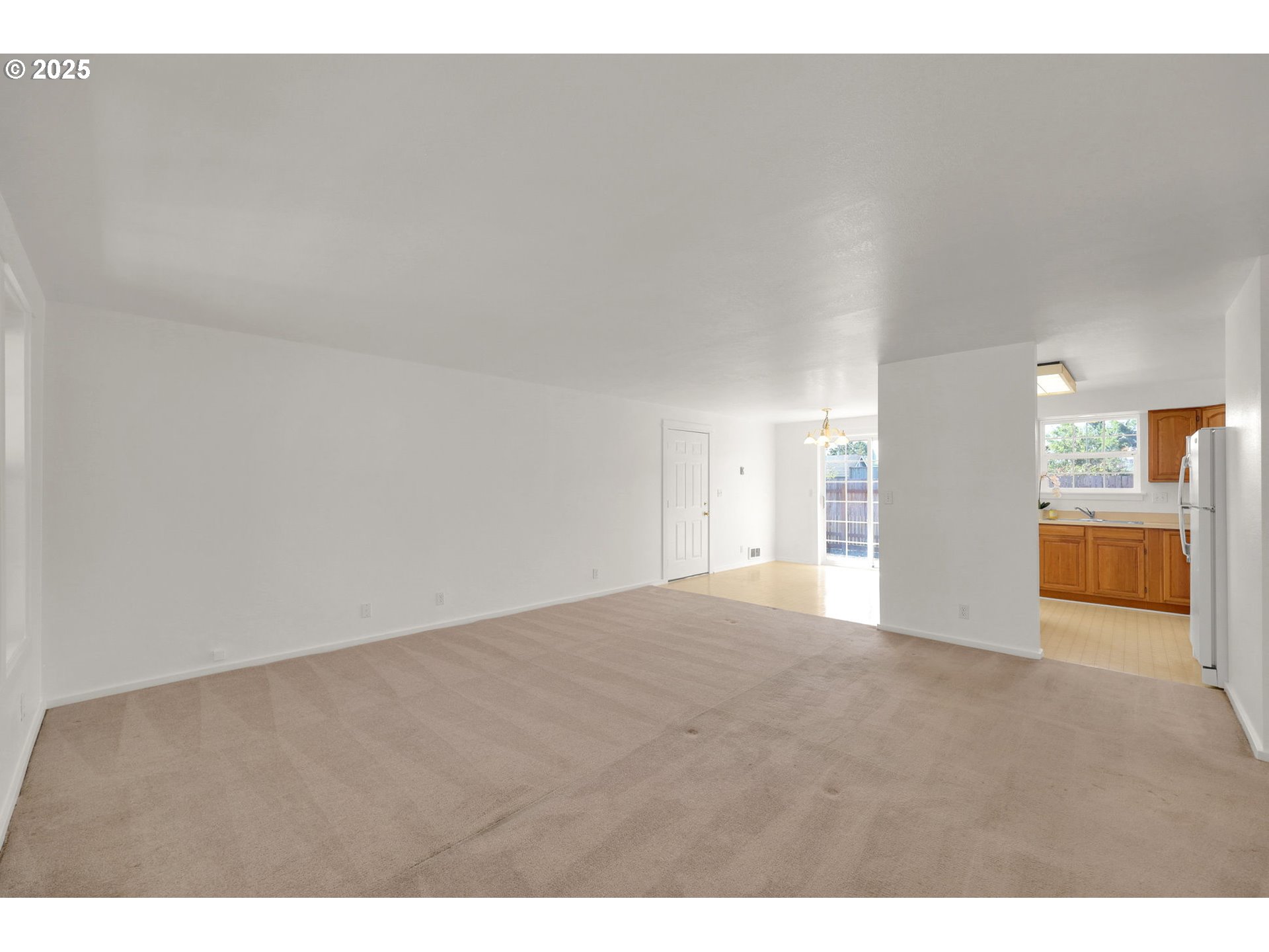 176 19th Street Springfield, OR 97477 - Photo 6 of 35 a view of an empty room and a kitchen