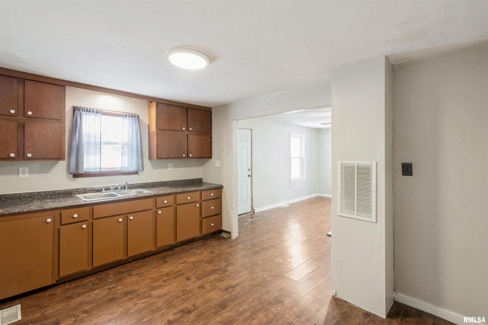 2207 4th Street Fulton, IL 61252 - Photo 6 of 11 a large bathroom with a granite countertop sink and a mirror