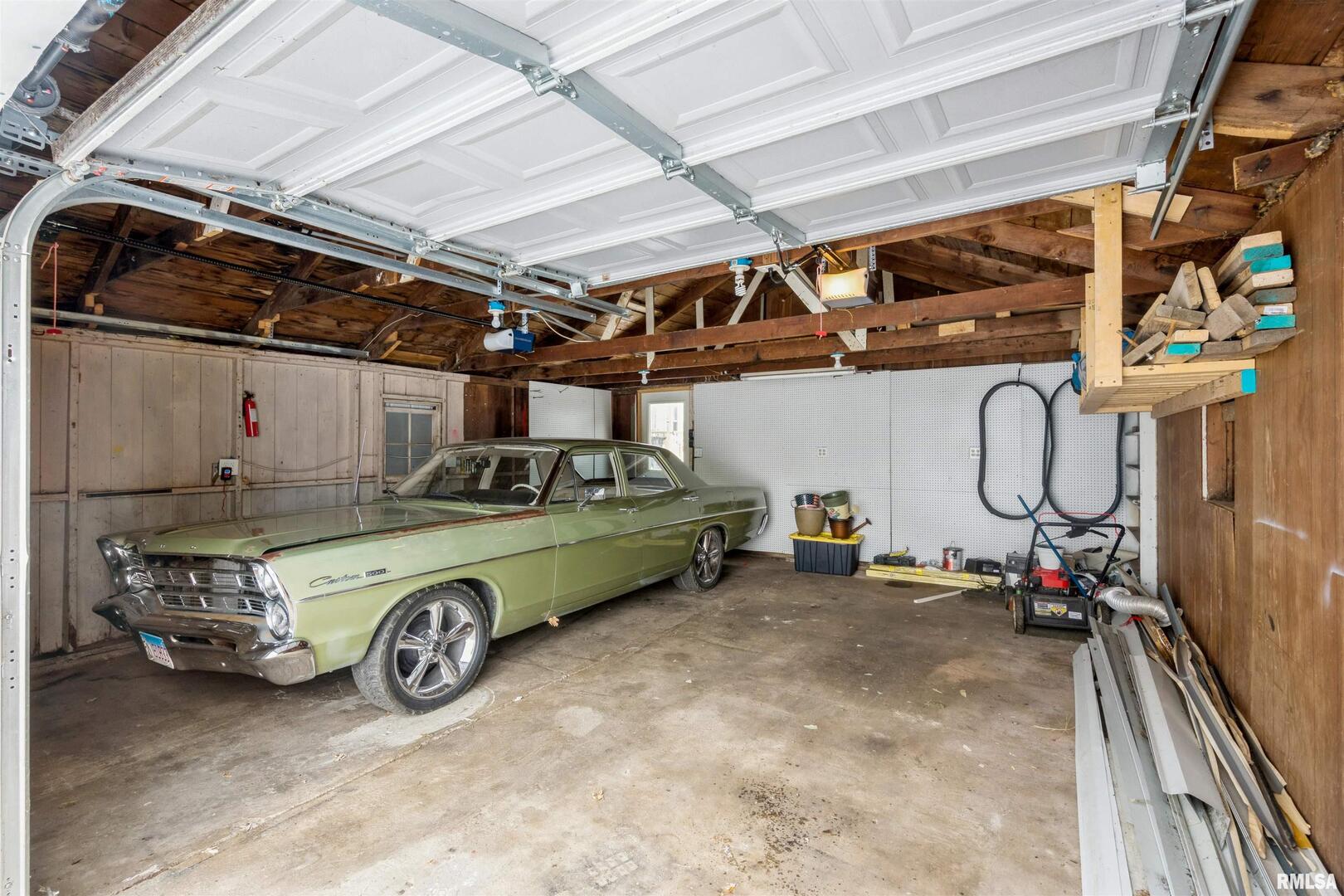 2207 4th Street Fulton, IL 61252 - Photo 10 of 11 a car and bike parked in a garage