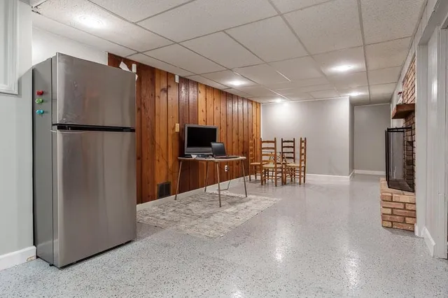 a kitchen with refrigerator and chairs