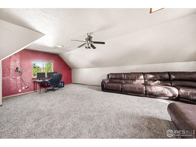 a view of a livingroom with furniture and a ceiling fan