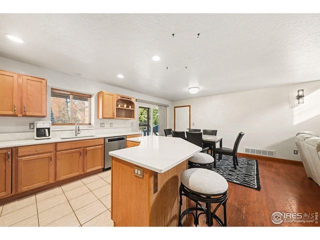 a kitchen with a sink cabinets and wooden floor