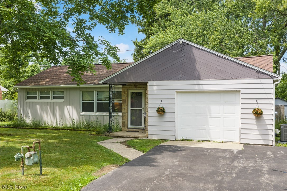 5768 Nolley Road Akron, OH 44319 - Photo 1 of 38 Ranch-style residence featuring a prominent single-car garage with a paved driveway