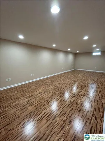a view of a room with wooden floor