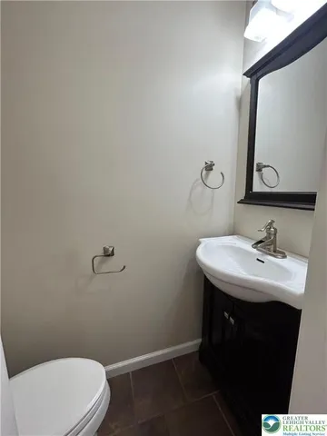 a bathroom with a sink toilet and mirror