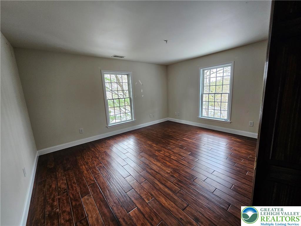 1 Dunminning Road Newtown Square, PA 19073 - Photo 12 of 30 an empty room with wooden floor and windows