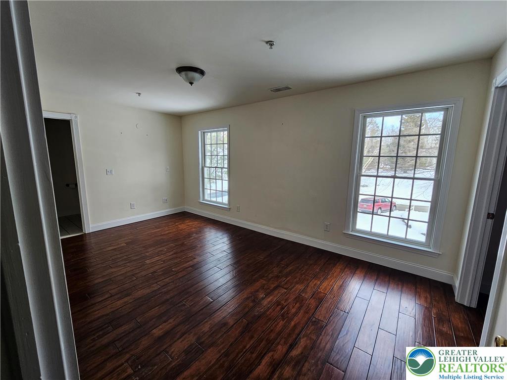 1 Dunminning Road Newtown Square, PA 19073 - Photo 21 of 30 an empty room with wooden floor and windows
