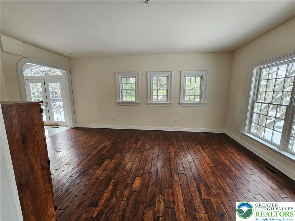 1 Dunminning Road Newtown Square, PA 19073 - Photo 5 of 30 an empty room with wooden floor and windows