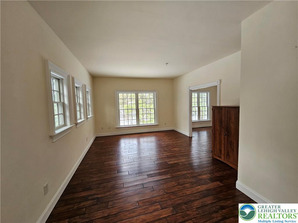 1 Dunminning Road Newtown Square, PA 19073 - Photo 6 of 30 a view of an empty room with wooden floor and a window