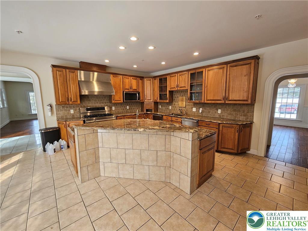 1 Dunminning Road Newtown Square, PA 19073 - Photo 8 of 30 a kitchen with stainless steel appliances granite countertop a stove a sink and a refrigerator
