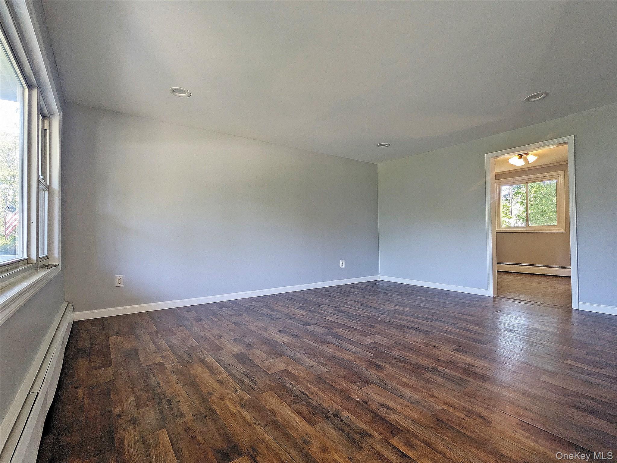 17 Belair Road Selden, NY 11784 - Photo 11 of 18 an empty room with wooden floor and windows