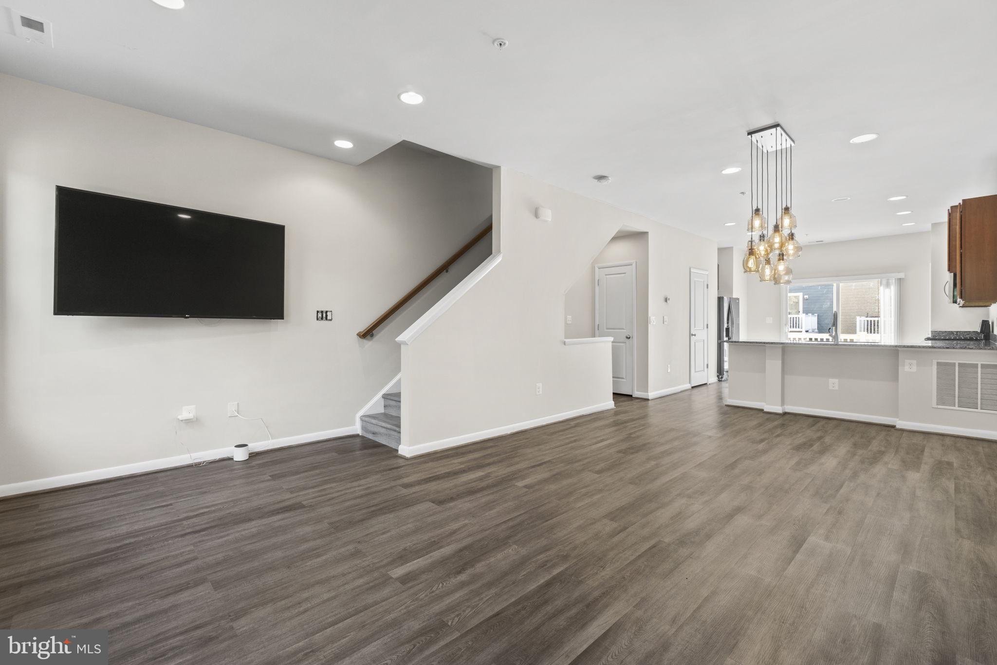 712 Hendrix Avenue Gaithersburg, MD 20878 - Photo 1 of 46 a view of a livingroom with wooden floor and a flat screen tv