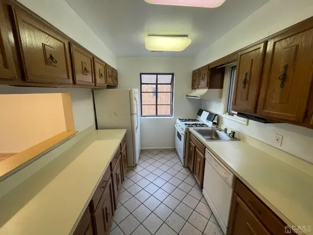 a kitchen with a sink a stove and cabinets