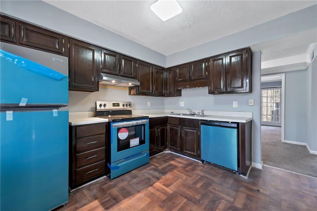 156 Glen Acres Court Decatur, GA 30035 - Photo 2 of 15 a kitchen with granite countertop stainless steel appliances and wooden cabinets