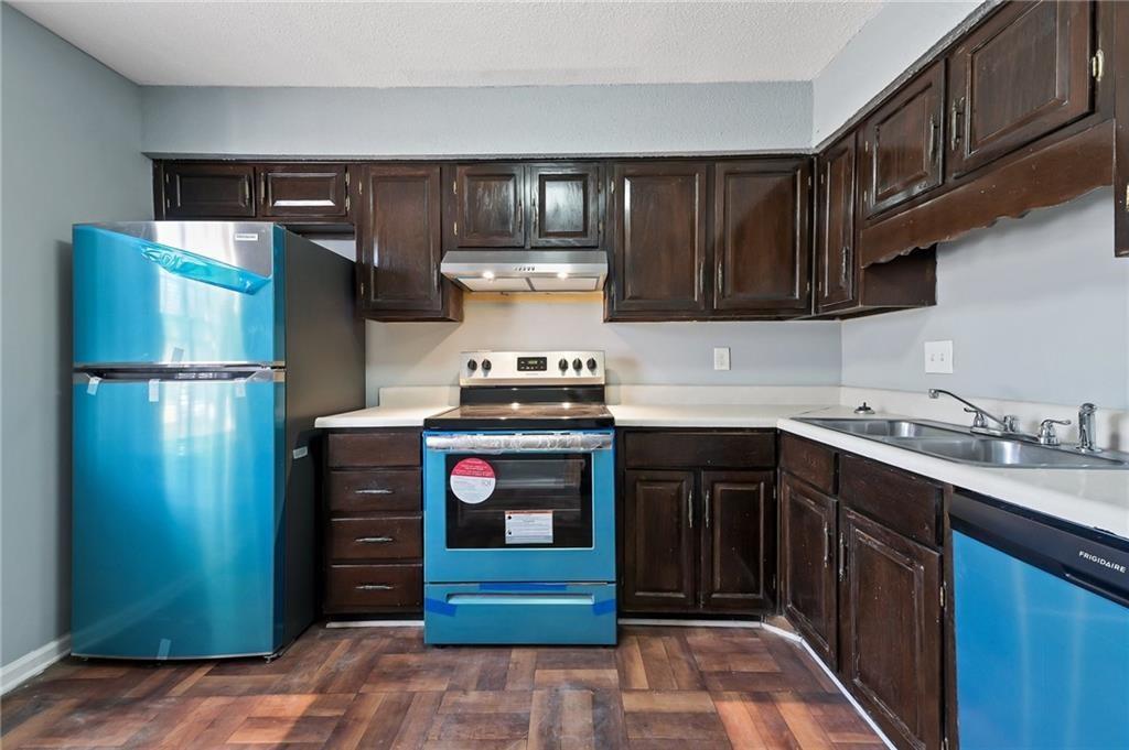 156 Glen Acres Court Decatur, GA 30035 - Photo 3 of 15 a kitchen with a refrigerator and a sink