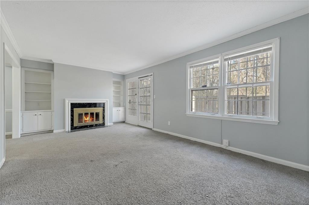 156 Glen Acres Court Decatur, GA 30035 - Photo 4 of 15 an empty room with a fireplace and a window