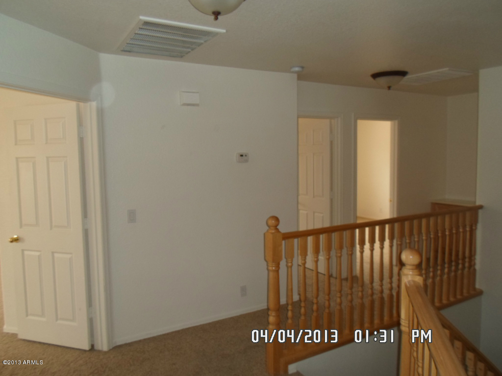 4047 East Agave Road Phoenix, AZ 85044 - Photo 15 of 20 a view of a hallway with wooden floor and a window