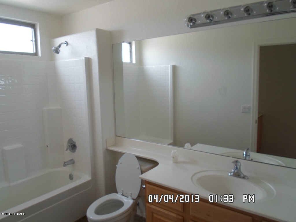 4047 East Agave Road Phoenix, AZ 85044 - Photo 18 of 20 a bathroom with a toilet and a sink