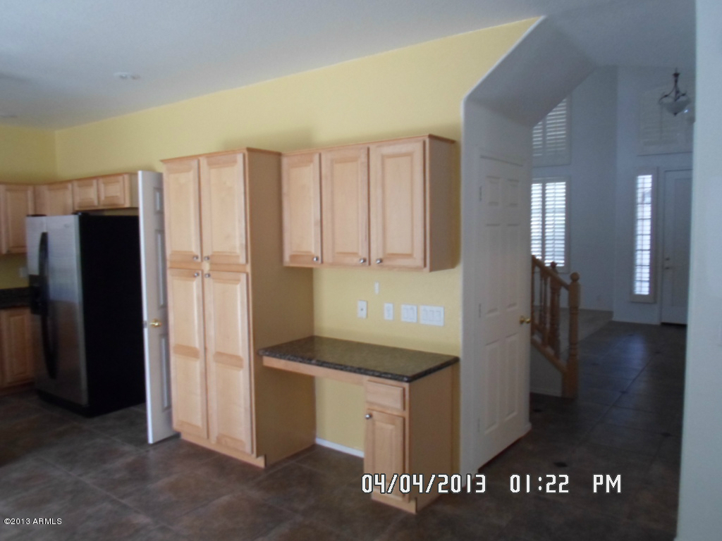 4047 East Agave Road Phoenix, AZ 85044 - Photo 10 of 20 a kitchen with stainless steel appliances granite countertop a refrigerator and a stove