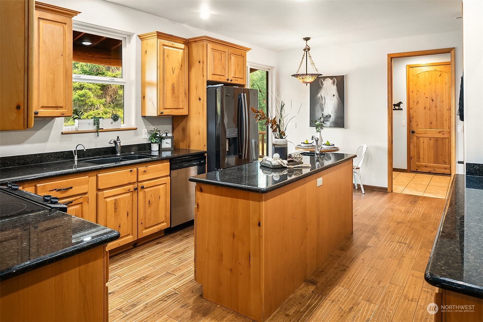 111 Chandler Road Cle Elum, WA 98922 - Photo 12 of 36 a kitchen with stainless steel appliances granite countertop a refrigerator a sink dishwasher a stove and white countertops with wooden floor