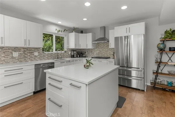 a kitchen with a sink stove and refrigerator