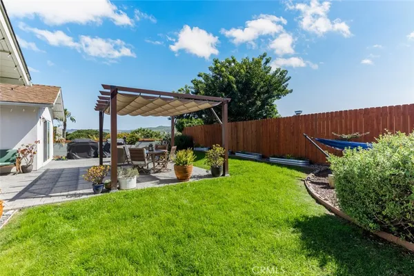 a view of a patio with dining table and chairs potted plants