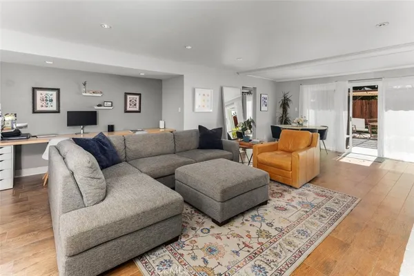 a living room with furniture and wooden floor