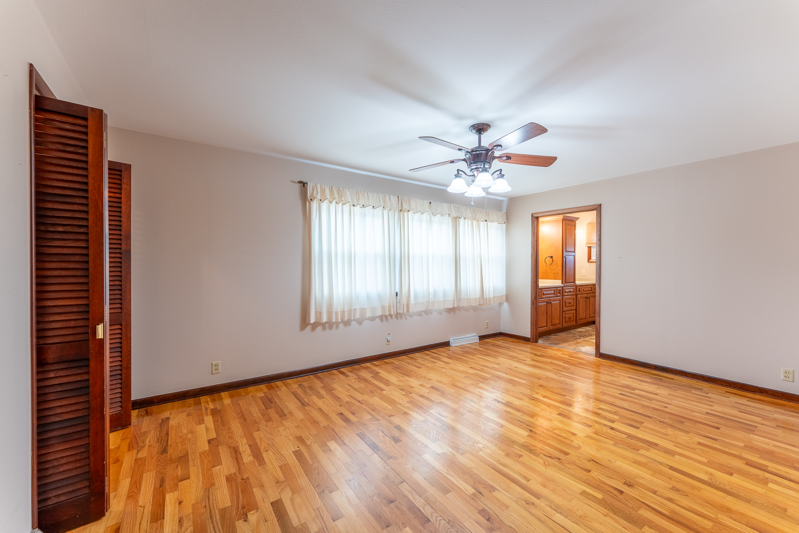212 Kane Drive Herrin, IL 62948 - Photo 17 of 44 an empty room with chandelier fan and windows