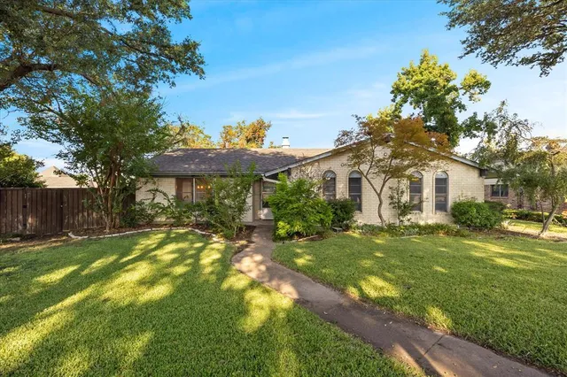 a front view of a house with a yard table and chairs