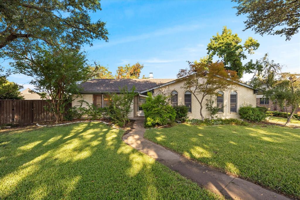 a front view of a house with a yard table and chairs