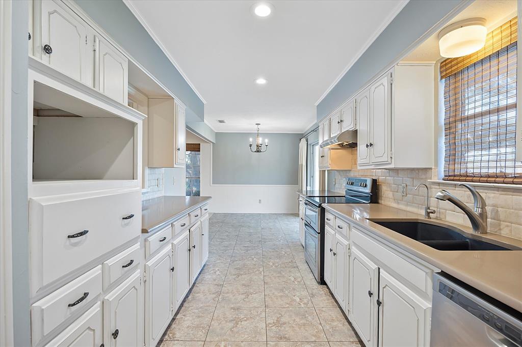 2733 Biloxi Lane Mesquite, TX 75150 - Photo 11 of 28 a kitchen with granite countertop a sink and cabinets