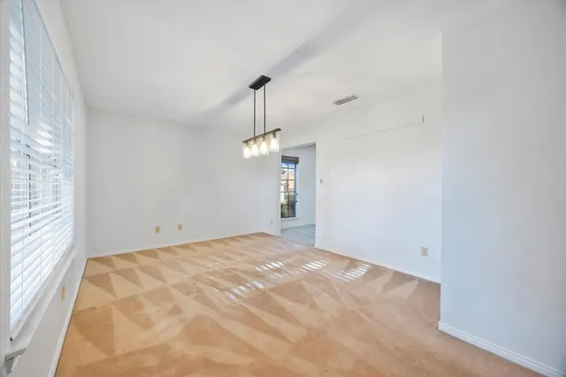 a view of an empty room with windows