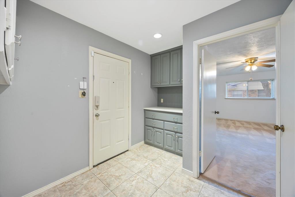 2733 Biloxi Lane Mesquite, TX 75150 - Photo 15 of 28 a view of a kitchen with a sink and dishwasher a refrigerator with white cabinets