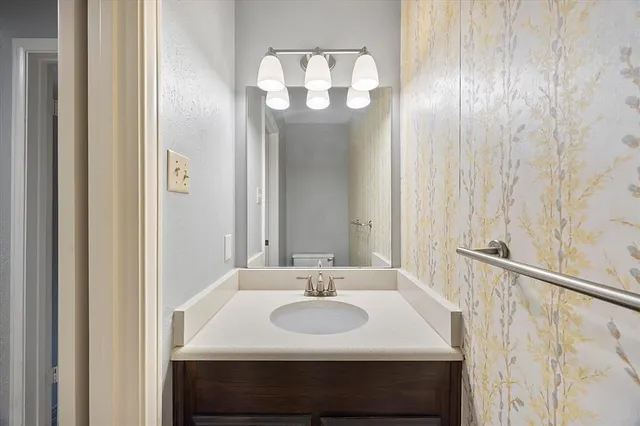 a view of an empty room with a chandelier fan